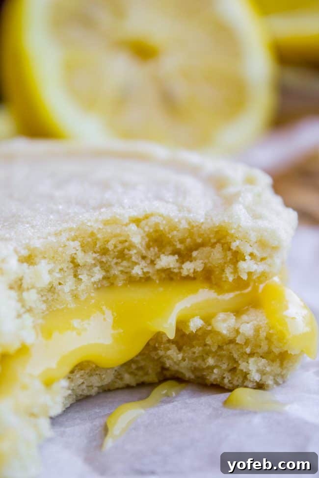 Easy Homemade Lemon Curd Swig Cookies - No Chill, No Roll Recipe Close-up of a stack of freshly baked lemon curd sugar cookie sandwiches, highlighting their soft texture and bright filling.