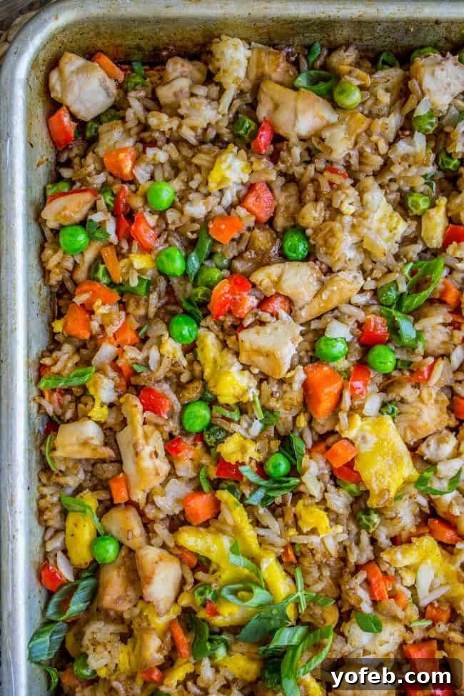 Delicious Sheet Pan Chicken Fried Rice, a full and hearty meal baked in the oven