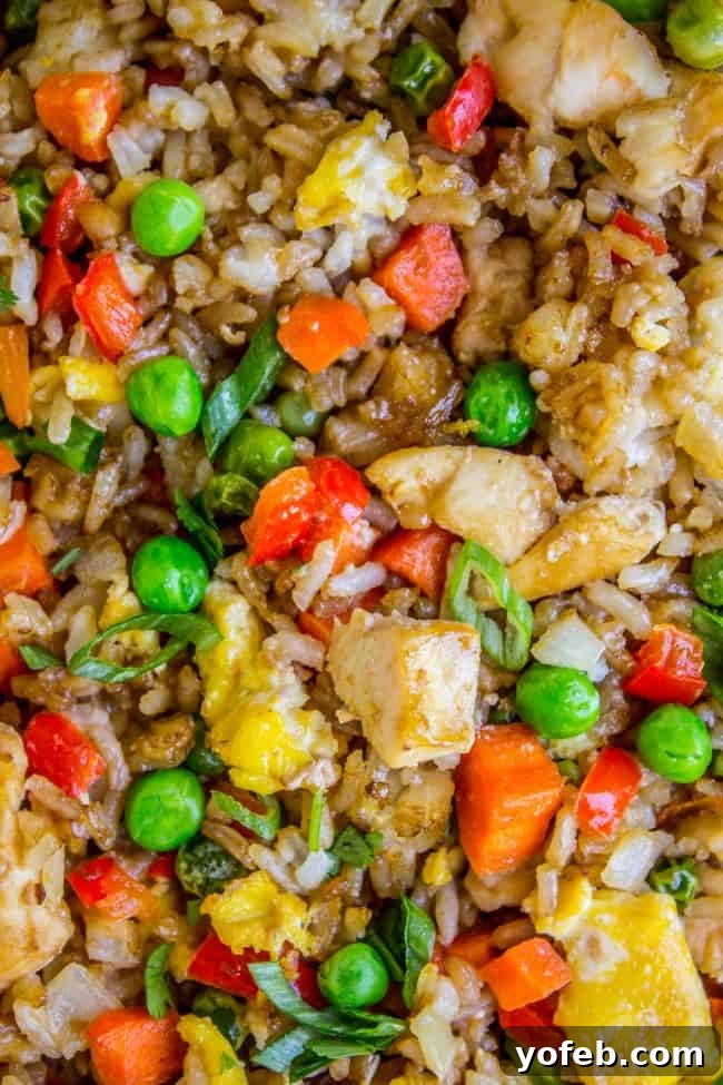 Hearty portion of Sheet Pan Chicken Fried Rice, highlighting golden rice grains and fresh vegetables