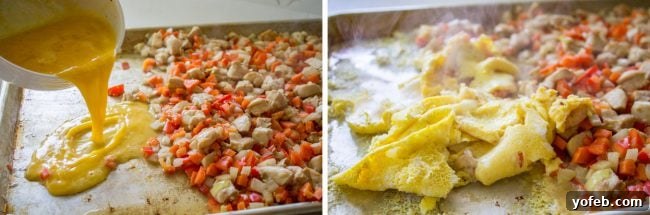 Beaten eggs being poured onto a sheet pan alongside chicken and vegetables for oven-baked fried rice