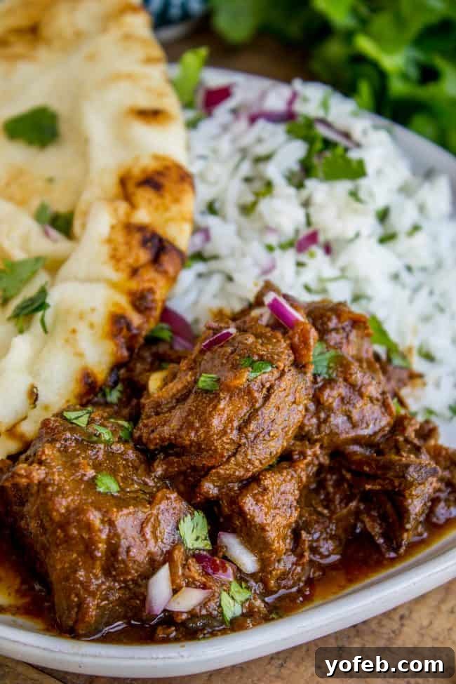 Slow Cooker Beef Curry: Unbelievably easy, tender beef in a rich, thick curry sauce, perfect with naan. Tender beef curry served with fragrant rice and fresh naan bread, garnished with vibrant cilantro. This Slow Cooker Beef Curry is incredibly easy and perfect for a cozy weeknight meal, bringing a rich, hearty flavor to your table.