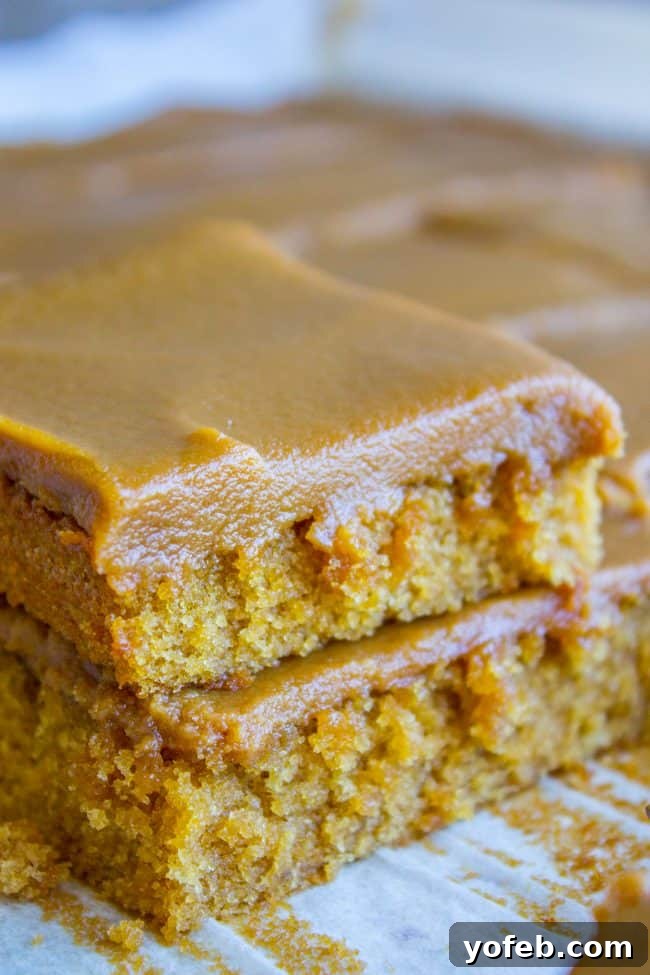 Caramel Cake Squares with Abundant Frosting Close-up of perfectly cut squares of caramel cake, each piece lavishly covered in a thick, smooth caramel frosting.