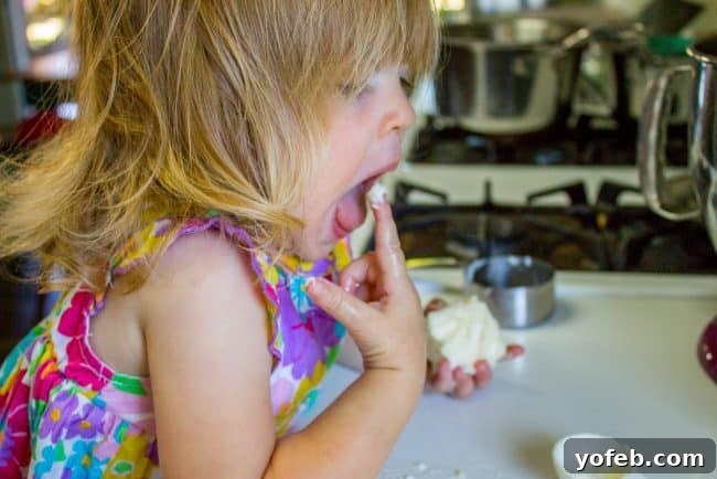 Caramel Cake Prep with a Toddler Helper A playful snapshot of a little girl, Valentine, enjoying butter, humorously depicting a baking hazard.