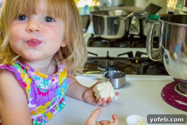 Butter-Loving Baby in the Kitchen Another image of the little girl, Valentine, with butter, adding a humorous touch to the baking narrative.