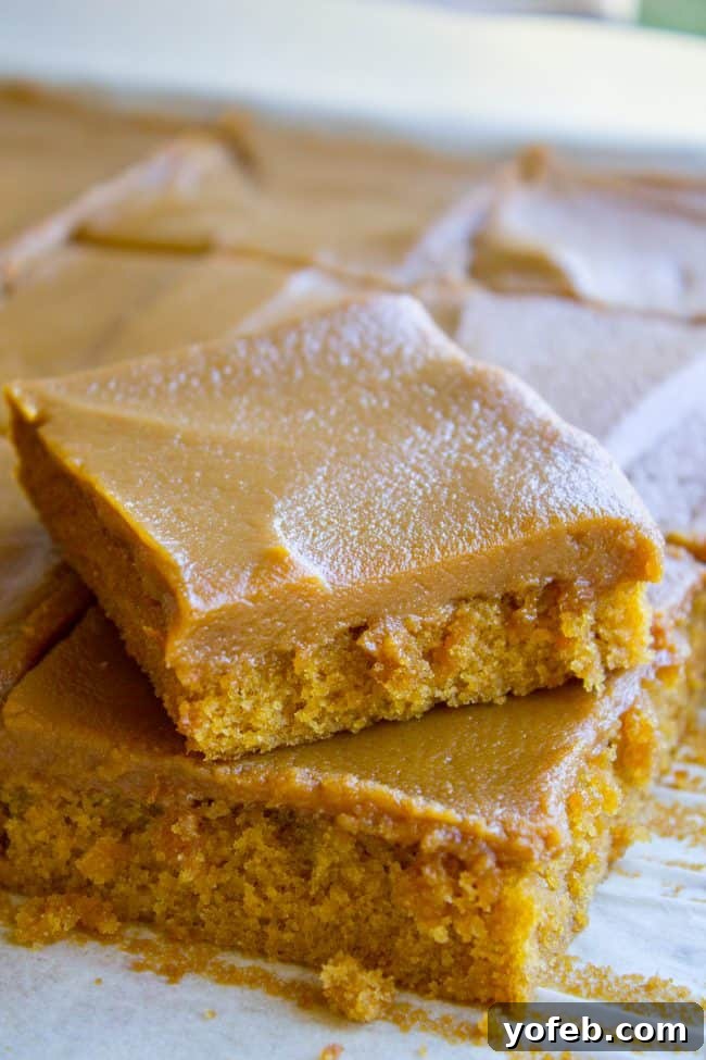 Decadent Caramel Icing on Cake Pieces An inviting close-up of individual pieces of caramel cake, lavishly coated with a rich, glistening caramel icing.