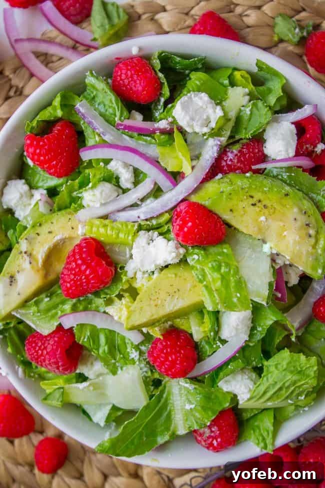 Delicious Goat Cheese Salad with Raspberries and Avocado. Close-up of a vibrant goat cheese salad with fresh raspberries and avocado slices.