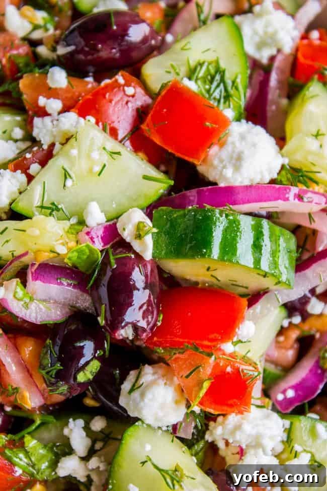 Greek Village Salad: Tomatoes, Cucumbers, and Feta Perfection 4 Close-up of a Greek salad with chopped cucumbers, tomatoes, red onions, kalamata olives, crumbled feta cheese, and fresh dill.