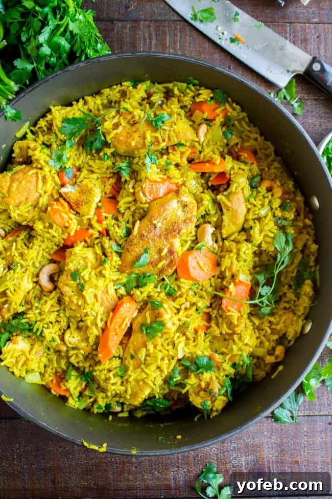 Aromatic Indian Chicken Biryani 3 Stovetop Chicken Biryani cooking in a large skillet, showing rice, chicken, and vegetables simmering together.