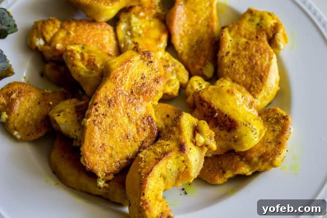 Aromatic Indian Chicken Biryani 9 Sautéed chicken strips coated in turmeric and curry powder in a skillet.