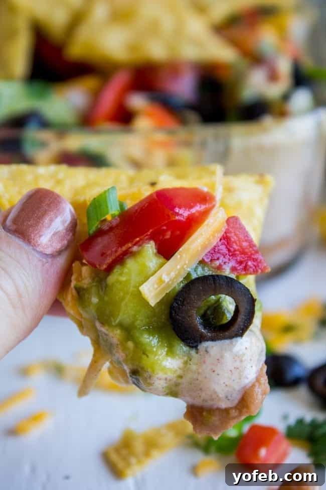 Carols Epic Seven Layer Bean Dip 4 7 layer bean dip on a chip.