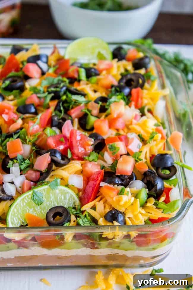 Carols Epic Seven Layer Bean Dip 6 7 layer dip recipe in casserole dish.