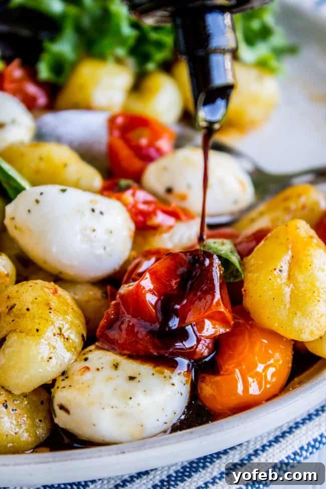 Sheet Pan Gnocchi drizzled with rich balsamic vinegar, highlighting the glossy finish and enhancing the vibrant colors of the dish.