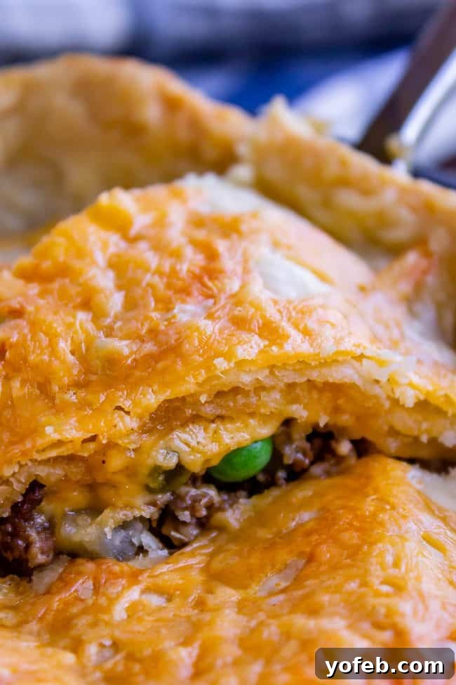 One Skillet Shepherd's Pot Pie from The Food Charlatan. It's like Shepherd's Pie and Chicken Pot Pie got together and had a baby to make a One Skillet Shepherd's Pot Pie! Regular skillet shepherd's pie would feature mashed potatoes, but instead we are covering ours up with a super flaky pie crust, just like it's a pot pie. It's comfort food heaven!! #recipe #easy #best #beef #traditional #skillet #castiron #casserole #withgravy #withcrust #cheddar #onepot #cheese #carrots #peas #flaky #crust skillet shepherds pie with golden crust