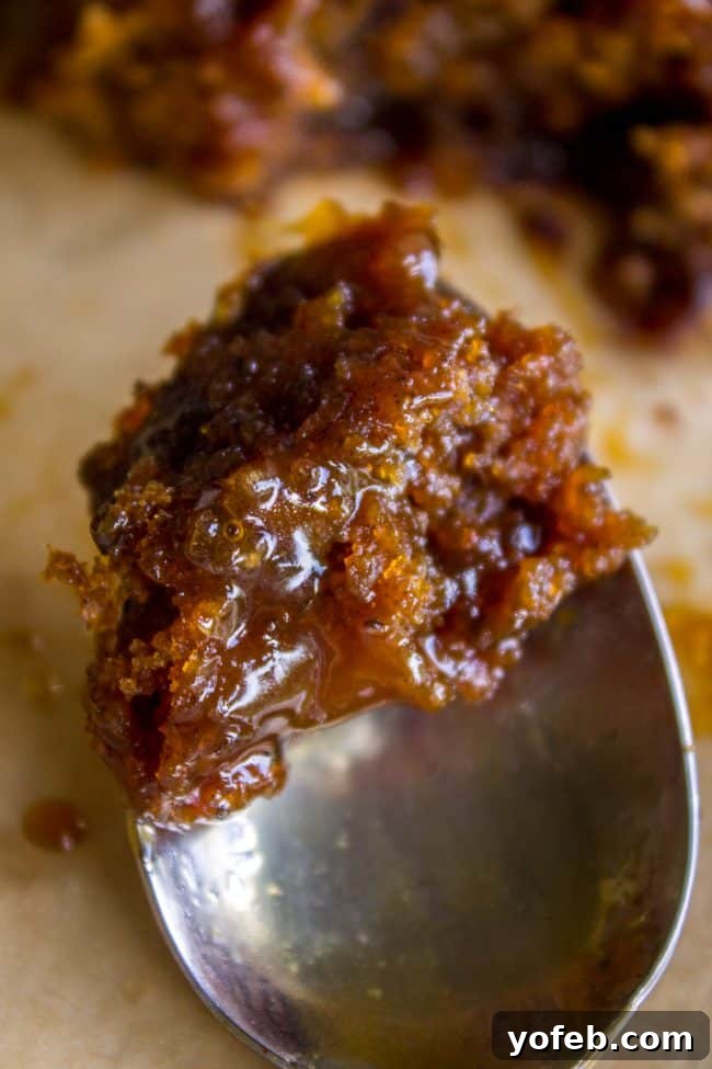 Ginger Sticky Toffee Pudding Cake from The Food Charlatan. This is a classic English dessert! The chopped dates make it incredibly moist as is, but then we go and dump buttery caramel sauce all over the top of it while it's warm. It's ridiculous and you will love it! #cake #pudding #english #englishpudding #toffee #sticky #ginger #recipe #easy #baked #dates #traditional #holidays #thanksgiving #Christmas #fall #fallbaking #spice #spicecake #caramel #caramelsauce Warm Ginger Sticky Toffee Pudding Cake drenched in luscious caramel sauce