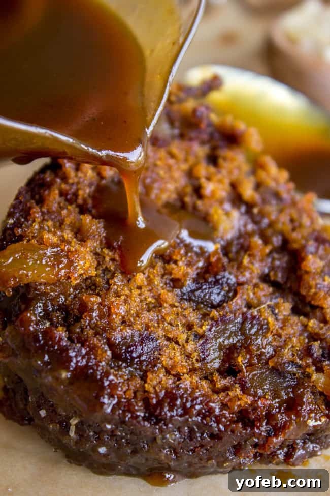 Ginger Sticky Toffee Pudding Cake from The Food Charlatan. This is a classic English dessert! The chopped dates make it incredibly moist as is, but then we go and dump buttery caramel sauce all over the top of it while it's warm. It's ridiculous and you will love it! #cake #pudding #english #englishpudding #toffee #sticky #ginger #recipe #easy #baked #dates #traditional #holidays #thanksgiving #Christmas #fall #fallbaking #spice #spicecake #caramel #caramelsauce Ginger Sticky Toffee Pudding Cake ready to be served