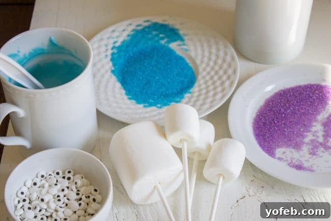 Dipping Marshmallows in Candy Melts: A key step for colorful Halloween pops. A hand carefully dipping a large marshmallow, skewered on a lollipop stick, into a mug filled with vibrant green melted candy, illustrating the coating process for marshmallow pops.