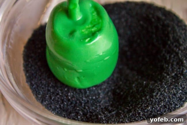 Decorating tools for Halloween Marshmallow Pops: Icing and edible marker. A selection of decorating tools for marshmallow pops, including tubes of black and white decorating icing with tips, and a black edible marker, essential for adding fine details and expressions.
