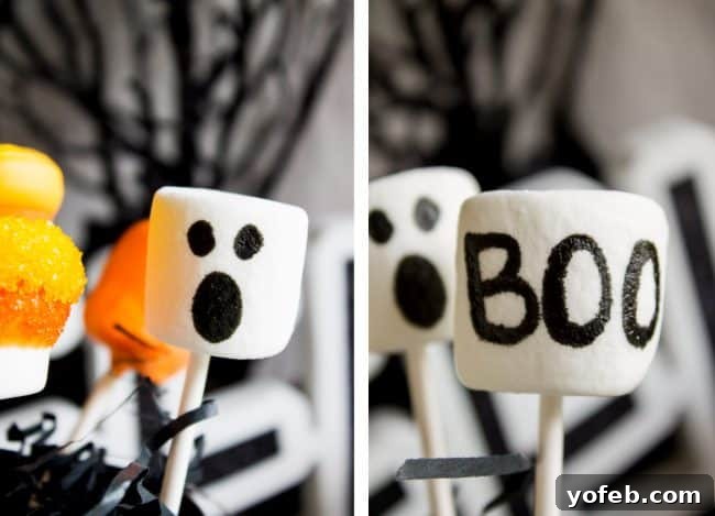 Variety of Halloween Marshmallow Pops: Perfect for party platters or individual favors. An overhead view capturing an assortment of vibrantly decorated Halloween marshmallow pops, including Frankenstein, ghosts, and mummies, neatly arranged on a baking sheet lined with parchment paper.