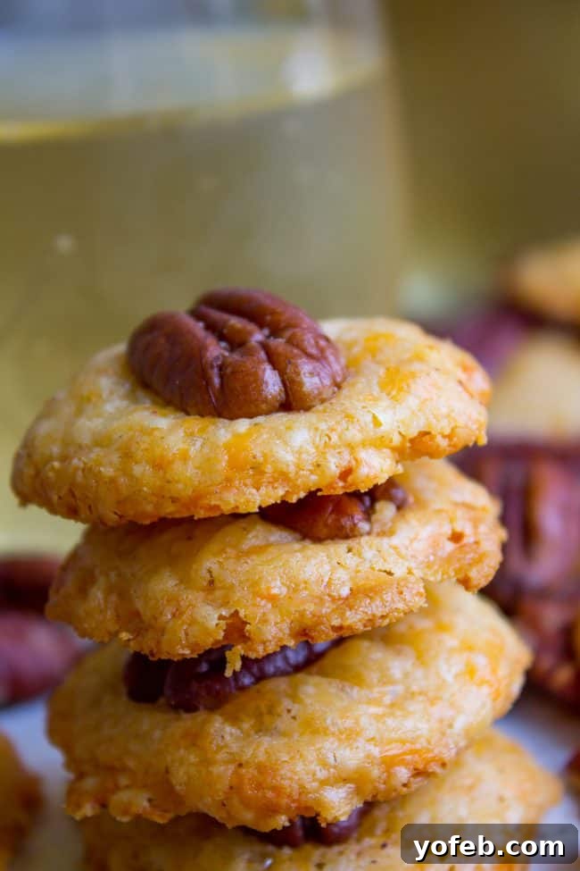 Holiday Southern Pecan Cheese Wafers 3 Close-up of baked Southern Pecan Cheese Wafers arranged neatly on a serving platter, highlighting their golden color and texture.