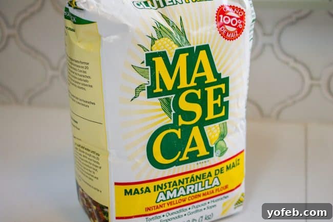 Mexican Masa Harina for authentic chili flavor. A bag of Maseca corn flour, labeled 'Masa Harina,' a key ingredient for authentic chili flavor and thickening.
