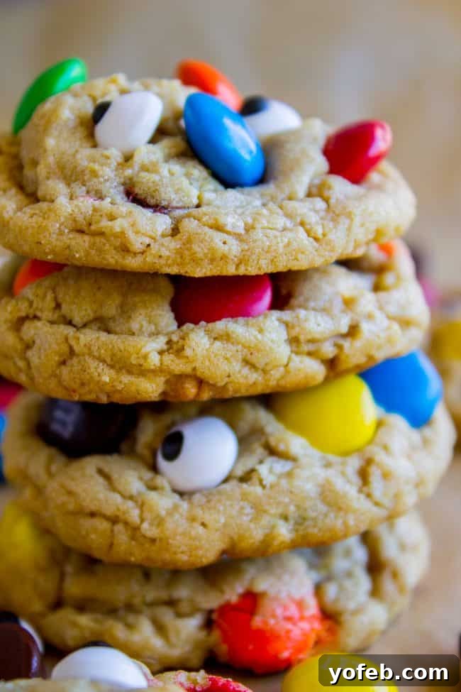 Stack of Monster Cookies A stack of soft and chewy monster cookies, showcasing their vibrant M&Ms and candy eyes.