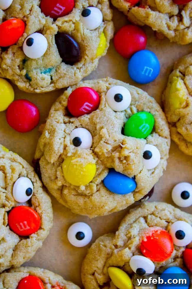 Monster cookies on baking sheet Baked monster cookies cooling on a baking sheet, ready for candy eyes and extra M&Ms.