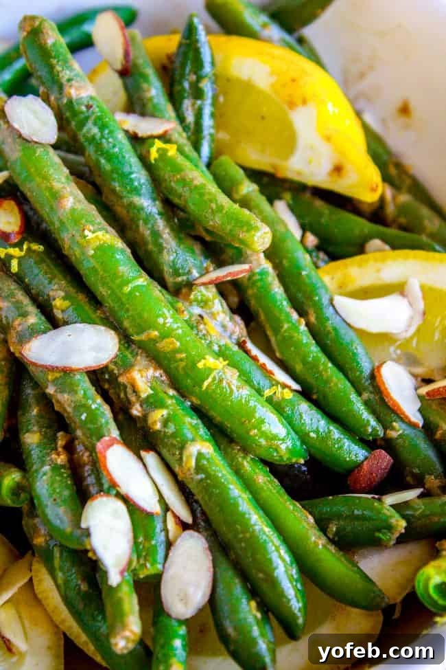 Bright Lemon Almond Green Beans 2 Vibrant green beans tossed with toasted almonds and lemon zest, glistening with butter.