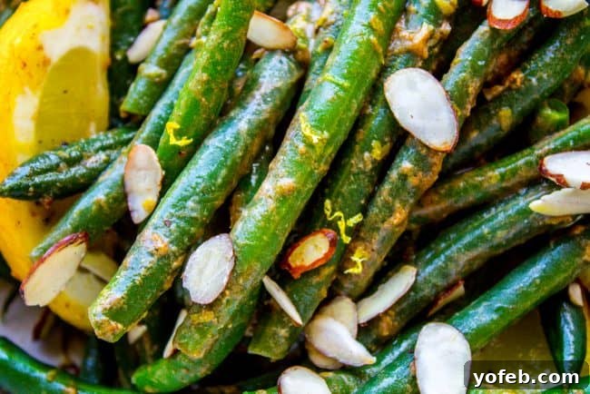 Bright Lemon Almond Green Beans 3 Close-up of garlic butter green beans, with visible minced garlic and a hint of lemon.