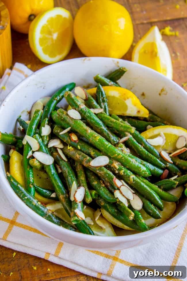 Bright Lemon Almond Green Beans 5 Green beans sautéing in a pan with lemons and almonds, creating a rich aroma.