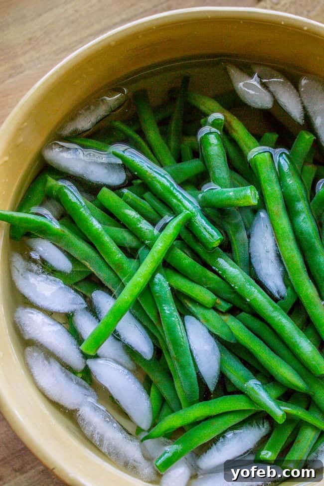 Bright Lemon Almond Green Beans 6 Fresh green beans being blanched in a pot of boiling water.