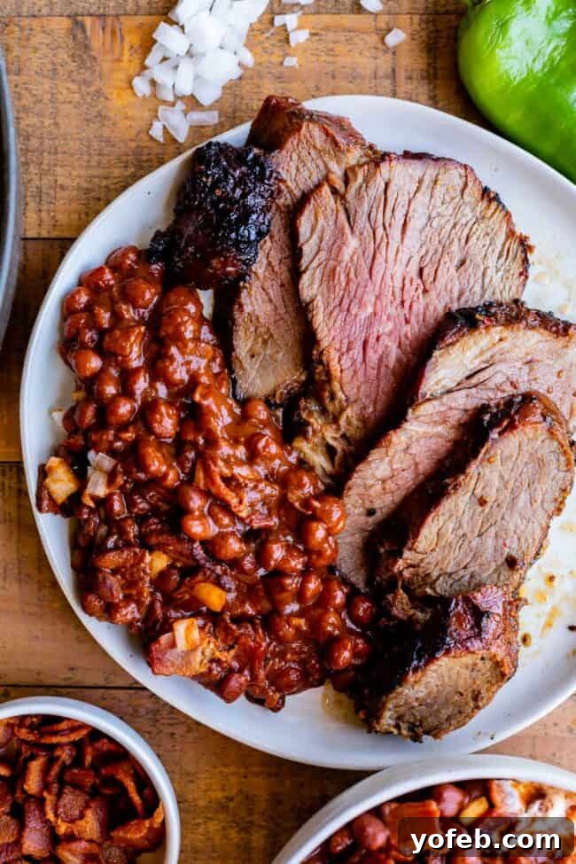 Perfectly Grilled or Roasted Tri Tip Steak 2 A plate featuring delicious Santa Maria pinquito beans served alongside slices of perfectly cooked tri-tip.