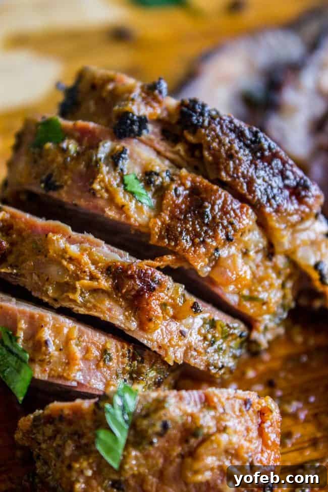 How to Cook Tri Tip (Grilled or Oven-Roasted) from The Food Charlatan. If you've never had tri tip, you haven't lived! I will show you how to cook tri tip on the grill or in the oven. It's SO easy and the flavor is unbeatable! We always had tri tip for Christmas dinner growing up, it's an impressive holiday dinner! A garlic marinade rub and tri tip roast recipe for a Christmas meal or summer bbq? Yes, please! All the tender, juicy, beefy goodness of steak but at a much more affordable price. Beautifully seared and sliced tri-tip steak, showing a perfect medium-rare interior and crispy, flavorful edges.