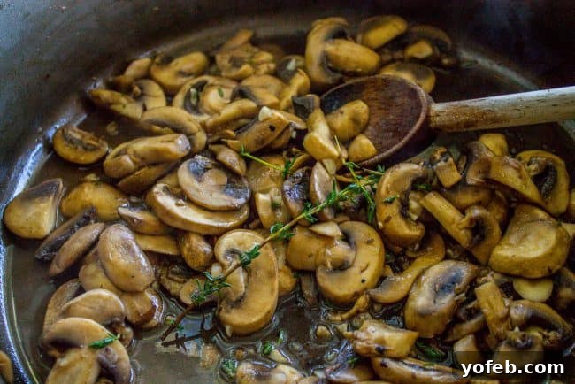Step-by-Step: Cooking Mushrooms for Green Bean Casserole Sautéing mushrooms with fresh thyme in a skillet.