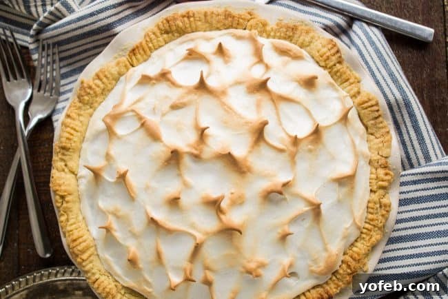 A beautifully set butterscotch pudding pie, chilled and ready to be sliced and served at a gathering.