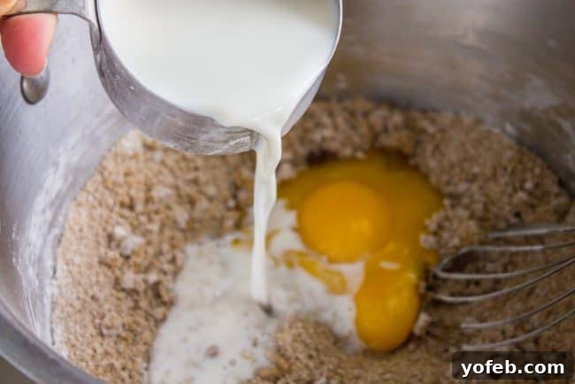A close-up showing the luscious butterscotch pudding filling being spread into a pre-baked pie crust.