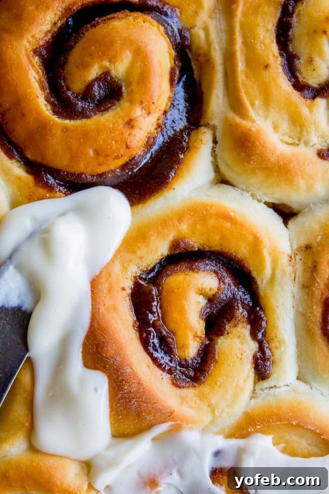 Freshly baked overnight cinnamon rolls, unfrosted and golden brown, ready for their sweet topping.
