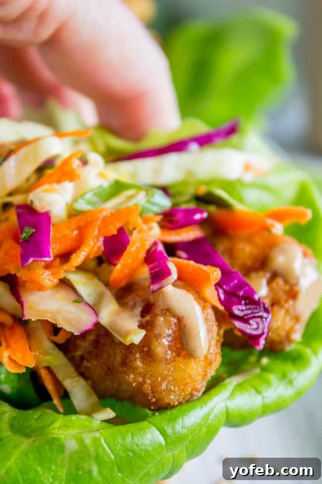 A close-up of a perfectly crafted Thai Lettuce Wrap, ready to enjoy. close up shot of a Thai lettuce wrap.