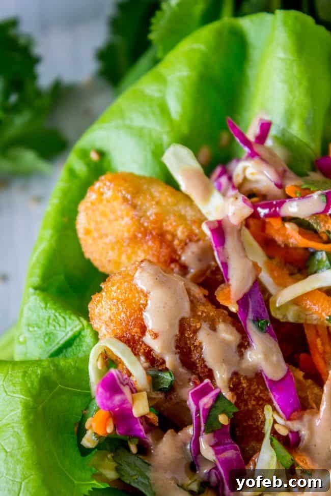 A close-up of a delectable fish lettuce wrap, ready to be enjoyed. close up shot of a fish taco in butter lettuce.
