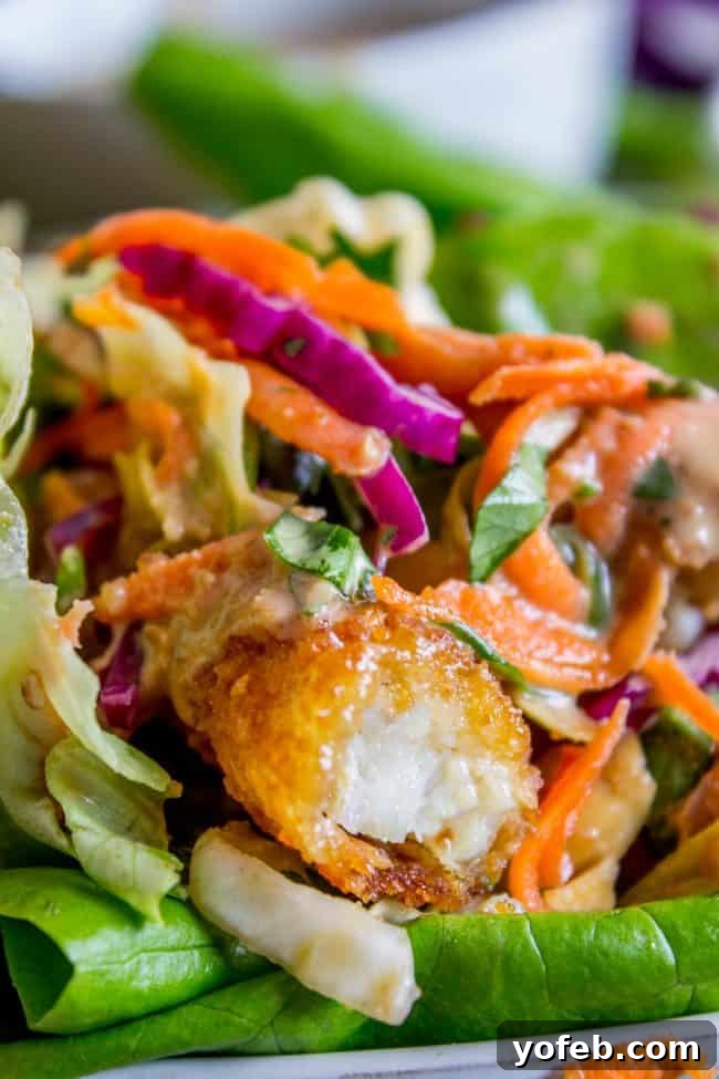 Irresistible Thai Lettuce Wrap: A symphony of flavors and textures. close up shot of a Thai lettuce wrap.