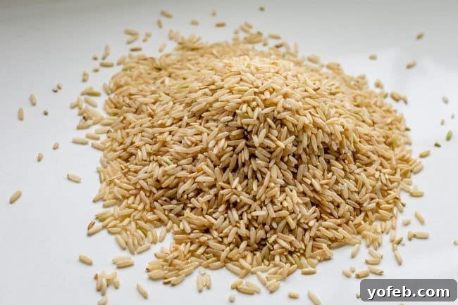 A perfectly cooked pile of fluffy brown rice, showcasing its inviting texture and golden hue, ready to be served.