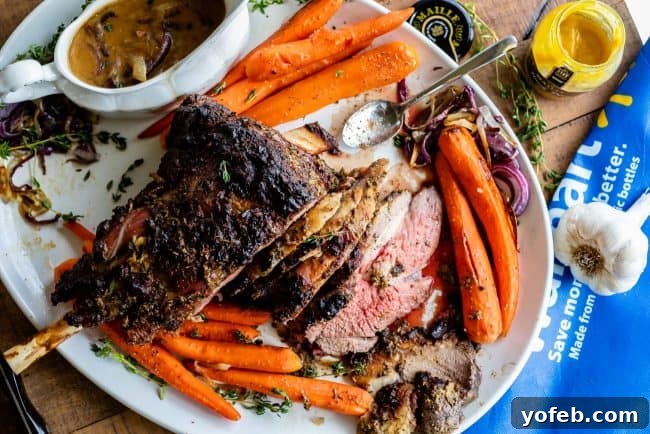 Holiday Lamb Dinner with Carrots and Gravy A beautifully presented roast lamb on a platter with roasted carrots, fresh herbs, a gravy boat filled with savory sauce, and a small bowl of honey Dijon mustard.