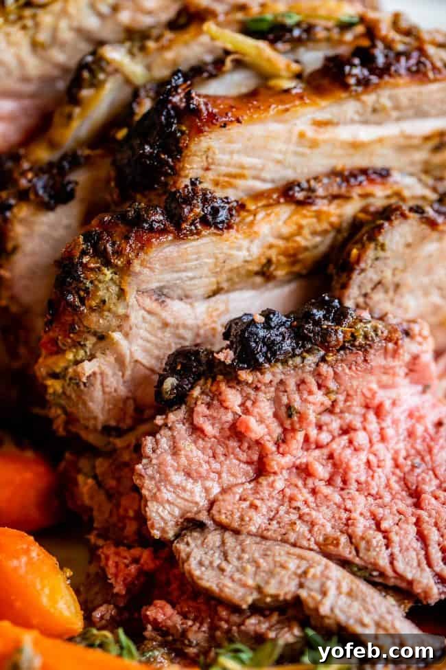 Perfectly Sliced Tender Roast Lamb Beautifully sliced roast leg of lamb, revealing its tender, juicy interior, arranged on a cutting board, ready to be served.