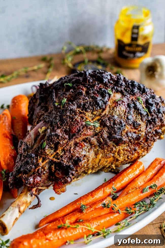 Whole Roast Lamb with Carrots and Thyme for Holiday Dinners A whole roast leg of lamb, beautifully browned with a crispy crust, presented on a platter alongside roasted carrots and fresh thyme sprigs.