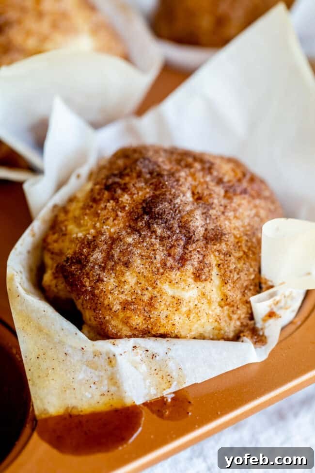 The delicious gooey interior of an Empty Tomb Roll after baking, where the marshmallow has transformed. A close-up of a partially eaten Empty Tomb Roll, showing the deliciously gooey, melted marshmallow caramel inside and the empty space.