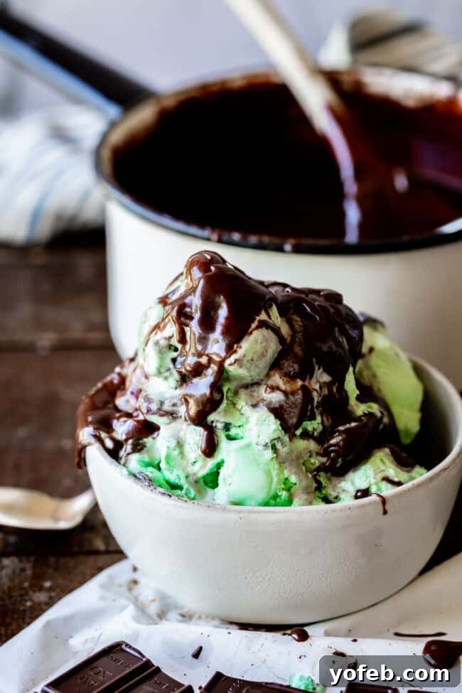Easy Homemade Chocolate Sauce 9 A generous swirl of homemade chocolate sauce sits atop a scoop of vanilla ice cream in a white bowl.