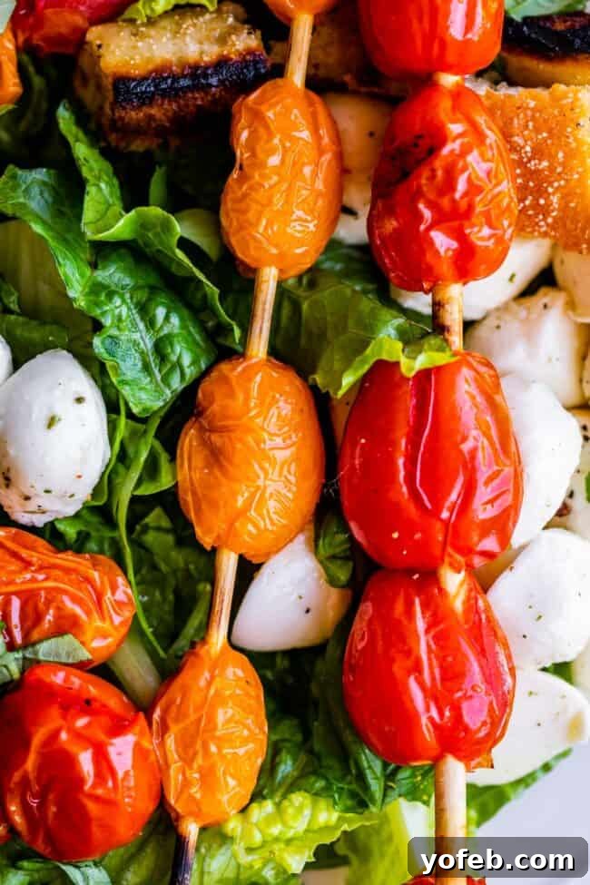 The Art of Grilling Tomatoes for a Flavorful Salad Close-up of grilled cherry tomatoes on skewers, showing the beautiful char