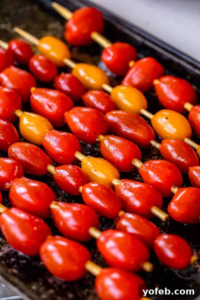 Step-by-Step Guide to Grilling Tomatoes for Your Caprese Salad Grilled cherry tomatoes on skewers ready to be added to Caprese salad