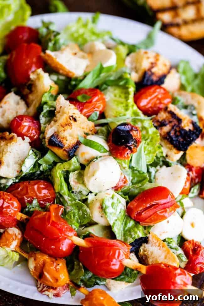 Why This Grilled Caprese Salad Will Become Your Go-To Summer Dish Beautifully arranged Grilled Tomato, Basil & Mozzarella Salad on a serving platter