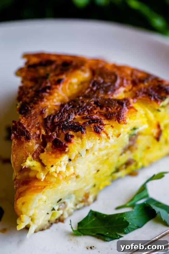 Easy 30-Minute Pasta Frittata with Sausage and Parmesan from The Food Charlatan. This dinner is done in 30 minutes and is so easy! The best part is that it uses mostly pantry ingredients (and sausage that you can freeze) so it's a good one to make when you haven't been shopping in a while! Swap out the veggies for whatever you have, and use leftover pasta if you have it! #leftoverspaghetti #recipes #dinners #eggs #cheese #Meals #brunch #dishes #breakfastrecipes #leftover #oliveoil #vegetables leftover pasta frittata - a close-up of a frittata slice, showing the well-incorporated pasta strands and the golden-brown bottom