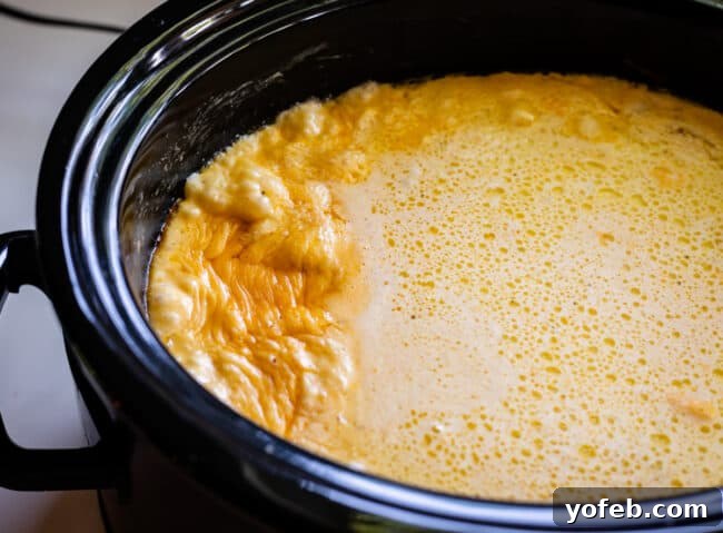 Mac and cheese in the slow cooker after 2 hours of cooking, visibly thicker and more integrated.
